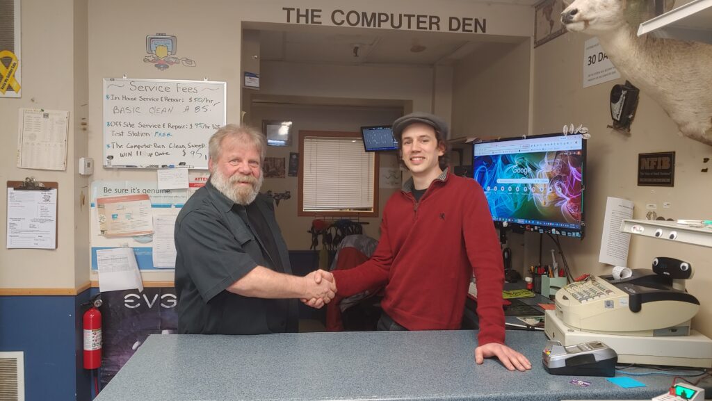 New and previous owner shaking hands